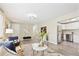 Open concept living area that flows into a bright kitchen with stainless steel appliances and bar seating at 6953 Elati Way, Denver, CO 80221