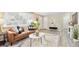 Inviting living room with stylish decor, brown leather sofa, and bright natural lighting at 6953 Elati Way, Denver, CO 80221