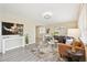 Bright living room featuring light wood flooring, stylish decor, and a cozy seating arrangement at 6953 Elati Way, Denver, CO 80221