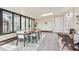 Sunroom features large windows, modern seating, and a light wood dining table with seating for six at 6953 Elati Way, Denver, CO 80221