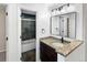Updated bathroom with stylish vanity, granite countertop, and tiled shower at 5480 W 74Th Ave, Arvada, CO 80003