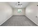 Bright bedroom with neutral walls, grey carpet, and modern ceiling fan with window at 5480 W 74Th Ave, Arvada, CO 80003