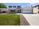 Inviting two-story home featuring a well-maintained lawn, brick accents, and an attached two-car garage at 5480 W 74Th Ave, Arvada, CO 80003
