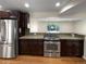 Well-equipped kitchen featuring stainless steel appliances, granite countertops, and dark wood cabinetry at 5480 W 74Th Ave, Arvada, CO 80003