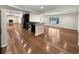 Spacious living room area with hardwood floors, fireplace, kitchen and natural light at 5480 W 74Th Ave, Arvada, CO 80003