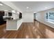 Open living space with hardwood floors flows into a modern kitchen with granite countertops and stainless appliances at 5480 W 74Th Ave, Arvada, CO 80003