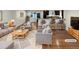 Bright, open-concept living room and kitchen area with hardwood floors and modern furnishings at 5480 W 74Th Ave, Arvada, CO 80003