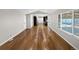 Open-concept space featuring hardwood floors and views of the kitchen and dining at 5480 W 74Th Ave, Arvada, CO 80003