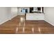 Spacious living area with gleaming hardwood floors flowing into the kitchen space at 5480 W 74Th Ave, Arvada, CO 80003
