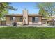 Spacious backyard with a patio, outdoor seating, and mature trees at 904 Fieldstone Pl, Highlands Ranch, CO 80126