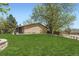 Large, green backyard with mature trees, landscaping, and a privacy fence at 904 Fieldstone Pl, Highlands Ranch, CO 80126