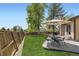 Backyard featuring a lush lawn, patio with a dining set, and privacy fencing at 904 Fieldstone Pl, Highlands Ranch, CO 80126