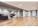Spacious basement with wood floors, seating area, and access to a bathroom at 904 Fieldstone Pl, Highlands Ranch, CO 80126
