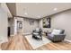 Finished basement featuring hardwood floors, comfortable seating, and modern decor with open door at 904 Fieldstone Pl, Highlands Ranch, CO 80126