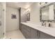 Modern bathroom featuring a dual sink vanity, sleek mirrors, and glass shower enclosure at 904 Fieldstone Pl, Highlands Ranch, CO 80126