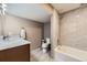 Cozy bathroom featuring marble tile, modern fixtures, and a combined bathtub and shower at 904 Fieldstone Pl, Highlands Ranch, CO 80126