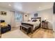 Well-lit bedroom featuring hardwood floors, a comfortable bed and bench, and stylish decor at 904 Fieldstone Pl, Highlands Ranch, CO 80126
