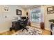 Well-lit home office featuring a large desk, ergonomic chair, and a comfortable decorative rug at 904 Fieldstone Pl, Highlands Ranch, CO 80126