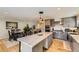 Open-concept kitchen with a large island, modern appliances, and hardwood floors, seamlessly connecting to the dining area at 904 Fieldstone Pl, Highlands Ranch, CO 80126