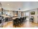Modern kitchen featuring stainless steel appliances, a large island with seating, and sleek gray cabinetry at 904 Fieldstone Pl, Highlands Ranch, CO 80126