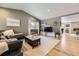 Cozy living room featuring a vaulted ceiling, hardwood floors, a plush sofa, and a decorative fireplace at 904 Fieldstone Pl, Highlands Ranch, CO 80126