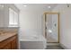 Elegant bathroom featuring a soaking tub, and glass enclosed shower at 3087 Deer Creek Trl, Highlands Ranch, CO 80129