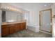 Spacious bathroom featuring double vanity, soaking tub, and glass enclosed shower at 3087 Deer Creek Trl, Highlands Ranch, CO 80129