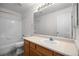 Bathroom featuring a vanity with wood cabinets, a large mirror, and a shower-tub combination at 3087 Deer Creek Trl, Highlands Ranch, CO 80129