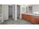 Bright bathroom with double sinks, and a walk-in closet adjacent to the commode at 3087 Deer Creek Trl, Highlands Ranch, CO 80129