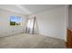 Empty bedroom with a bright window and neutral carpet at 3087 Deer Creek Trl, Highlands Ranch, CO 80129
