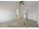 Spacious bedroom with neutral colored carpet and easy access to the ensuite bathroom at 3087 Deer Creek Trl, Highlands Ranch, CO 80129