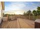 Spacious wooden deck with railings offers stunning views of the surrounding landscape and distant mountains at 3087 Deer Creek Trl, Highlands Ranch, CO 80129
