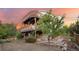 Two-story home with a wooden deck and lush backyard at dusk at 3087 Deer Creek Trl, Highlands Ranch, CO 80129