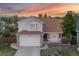 Charming home showcases a well-kept lawn, pristine driveway, attached garage, and inviting front porch at 3087 Deer Creek Trl, Highlands Ranch, CO 80129