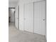 Hallway with two large closet doors and grey carpet, leading to other rooms at 3087 Deer Creek Trl, Highlands Ranch, CO 80129