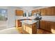 Charming kitchen featuring wood cabinets, a kitchen island, stainless steel appliances, and hardwood floors at 3087 Deer Creek Trl, Highlands Ranch, CO 80129