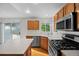 Bright kitchen with stainless steel appliances and an island; the sliding glass door allows for natural light at 3087 Deer Creek Trl, Highlands Ranch, CO 80129