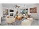 Bright and inviting living room features a cozy fireplace, plush seating, and large windows at 3087 Deer Creek Trl, Highlands Ranch, CO 80129