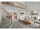 Open floor plan features stairs, a cozy living area with modern decor and an adjacent kitchen at 3087 Deer Creek Trl, Highlands Ranch, CO 80129