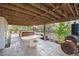 Covered outdoor living space featuring a hot tub, stone patio, and open design at 3087 Deer Creek Trl, Highlands Ranch, CO 80129