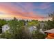 Scenic view of the neighborhood with trees, houses and mountains in the background, at sunset at 3087 Deer Creek Trl, Highlands Ranch, CO 80129