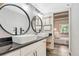 Bright bathroom showcasing dual vanities, modern fixtures, and easy access to the bedroom at 2525 S Dayton Way # 2209, Denver, CO 80231