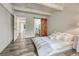 Calm bedroom with hardwood flooring, concrete beams, barn door, and sliding door closet at 2525 S Dayton Way # 2209, Denver, CO 80231
