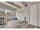 Bedroom featuring wood floors, exposed beam ceilings, and an exercise area with a large window view at 2525 S Dayton Way # 2209, Denver, CO 80231