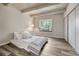 Calm bedroom with window seat, hardwood flooring, concrete beams, and modern closet at 2525 S Dayton Way # 2209, Denver, CO 80231