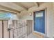 Inviting front entryway with a blue front door, a welcome mat, and a charming wooden gate at 2525 S Dayton Way # 2209, Denver, CO 80231