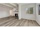 Open concept living area featuring a fireplace, exposed ceiling beams, and wood-look flooring at 2525 S Dayton Way # 2209, Denver, CO 80231