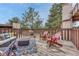 Outdoor deck featuring cozy seating, colorful cushions, and a charming fireplace at 2525 S Dayton Way # 2209, Denver, CO 80231