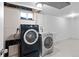 Laundry room with newer washer and dryer units and utility sink at 1862 Queens Dr, Longmont, CO 80501