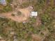 Unique property featuring an aerial view showcasing a charming house, outbuilding and surrounding landscape at 26349 Pleasant Park Rd, Conifer, CO 80433